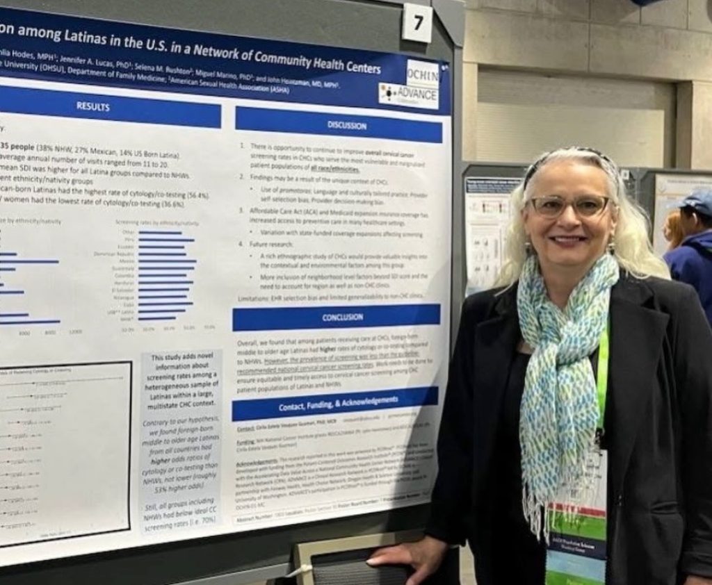 Selena Rushton stands with poster presented at AACR 2026
