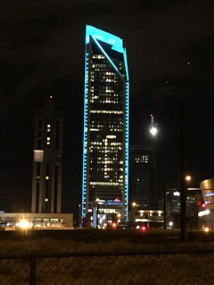 The Duke Energy Building in Charlotte lit up in teal light