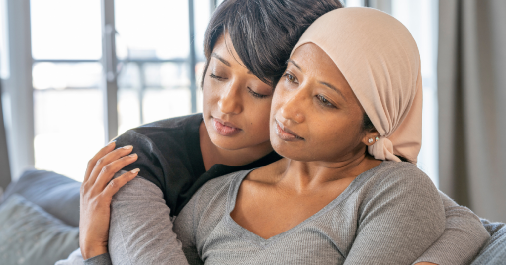 Two women embrace in a show of support